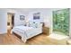 Bright bedroom features hardwood floors, closet, and large windows to view greenery at 3910 Somerset Dr, Durham, NC 27707