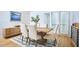 Inviting dining room with a wooden table, cushioned chairs, rug, and natural light from sliding glass doors at 3910 Somerset Dr, Durham, NC 27707
