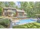 Beautiful two-story home with a pool, patio, landscaped yard and surrounded by lush trees at 3910 Somerset Dr, Durham, NC 27707