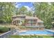 Back exterior view of house with swimming pool, patio, deck, and well-manicured landscaping at 3910 Somerset Dr, Durham, NC 27707