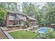 Spacious two-story home with a pool, well-manicured yard, and lush landscaping at 3910 Somerset Dr, Durham, NC 27707