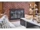 Living room fireplace featuring brick surround and hearth, with black trim at 3910 Somerset Dr, Durham, NC 27707