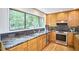Modern kitchen with stainless steel appliances, granite countertops, and a large window at 3910 Somerset Dr, Durham, NC 27707