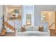 Bright living room featuring modern staircase, wood floors, and stylish furniture for comfortable living at 3910 Somerset Dr, Durham, NC 27707
