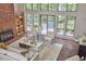 Bright living room features a cozy brick fireplace and large windows with beautiful outdoor views at 3910 Somerset Dr, Durham, NC 27707