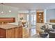 Open-concept living area featuring a dining table, sofa, hardwood floors, and modern lighting fixtures at 3910 Somerset Dr, Durham, NC 27707