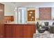 Contemporary living room featuring wooden cabinetry, an open floor plan, hardwood floors, and a gray sofa at 3910 Somerset Dr, Durham, NC 27707