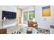 Open concept living room with modern decor, including a large television, contemporary art, and stylish furniture at 3910 Somerset Dr, Durham, NC 27707
