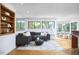 Spacious living room featuring a comfortable sectional sofa, hardwood flooring, and natural light from expansive windows at 3910 Somerset Dr, Durham, NC 27707
