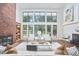 Spacious living room with large windows, brick fireplace, and stylish decor for comfortable living at 3910 Somerset Dr, Durham, NC 27707