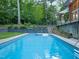 Beautiful in-ground pool with lush landscaping and terraced gardens at 3910 Somerset Dr, Durham, NC 27707