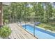 Backyard deck with a pool, greenery and an outdoor kitchen and dining area at 3910 Somerset Dr, Durham, NC 27707