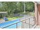 A gorgeous in-ground pool and landscaped backyard, as seen from the deck at 3910 Somerset Dr, Durham, NC 27707