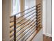 Modern staircase featuring a sleek, horizontal railing design and hardwood flooring at 3910 Somerset Dr, Durham, NC 27707