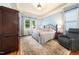 Spacious bedroom with hardwood floors, tray ceiling, and an area rug creating a comfortable and stylish retreat at 3916 Rustic Mill Dr, Apex, NC 27539