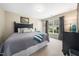 Bedroom with a gray comforter, an oak headboard, and a large window with gray curtains at 3916 Rustic Mill Dr, Apex, NC 27539
