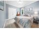 Bedroom with a queen bed, a dresser with a mirror, a window, and double closets at 3916 Rustic Mill Dr, Apex, NC 27539