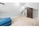 Unfinished bonus room with a blue ottoman and a large wardrobe at 3916 Rustic Mill Dr, Apex, NC 27539