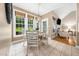 Bright dining area with a view of the outdoor fireplace and backyard featuring a fireplace and comfortable seating at 3916 Rustic Mill Dr, Apex, NC 27539