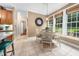 Bright dining area features tile flooring, large windows, and a charming chandelier for comfortable eating and entertaining at 3916 Rustic Mill Dr, Apex, NC 27539