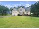 Charming two-story home with a well-manicured lawn and attached two-car garage in a lush green neighborhood at 3916 Rustic Mill Dr, Apex, NC 27539