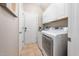Bright and clean laundry room featuring a washer, dryer, and storage cabinets for convenient laundry tasks at 3916 Rustic Mill Dr, Apex, NC 27539
