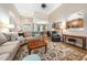Spacious living room with hardwood floors, a comfortable sofa, and a decorative rug creating a welcoming space at 3916 Rustic Mill Dr, Apex, NC 27539