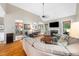 Open-concept living room featuring hardwood floors, a fireplace, and a view of the kitchen and dining area at 3916 Rustic Mill Dr, Apex, NC 27539