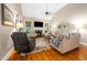 Inviting living room featuring a fireplace, plush seating, and hardwood floors, perfect for relaxation at 3916 Rustic Mill Dr, Apex, NC 27539