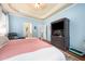 A serene main bedroom featuring a tray ceiling and a dark wood entertainment center at 3916 Rustic Mill Dr, Apex, NC 27539