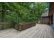 Spacious wooden deck offers serene views of the lush surrounding forest, perfect for outdoor relaxation at 4272 Boyd Wright Rd, Burlington, NC 27215