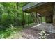 Landscaped backyard featuring wooden stairs leading to deck and wooded area at 4272 Boyd Wright Rd, Burlington, NC 27215