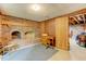 Basement featuring a brick fireplace, desk, and door to unfinished area at 4272 Boyd Wright Rd, Burlington, NC 27215