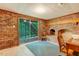 Basement with brick fireplace, sliding glass door to backyard, and vintage desk at 4272 Boyd Wright Rd, Burlington, NC 27215