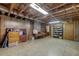 Spacious unfinished basement with exposed brick, storage, and shelving at 4272 Boyd Wright Rd, Burlington, NC 27215