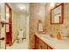 Quaint bathroom with floral wallpaper, traditional vanity, and shower-tub combo at 4272 Boyd Wright Rd, Burlington, NC 27215
