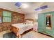 Bedroom featuring painted ceiling, brick wall, wood bedframe, and a closet at 4272 Boyd Wright Rd, Burlington, NC 27215