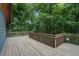 Expansive wooden deck overlooking a lush, green, wooded backyard at 4272 Boyd Wright Rd, Burlington, NC 27215