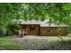 Ranch style home featuring a combination of wood and brick with a front porch and natural surroundings at 4272 Boyd Wright Rd, Burlington, NC 27215