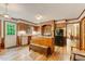 Cozy kitchen featuring wood cabinets, a brick cooking area, stainless steel appliances, and wood flooring at 4272 Boyd Wright Rd, Burlington, NC 27215