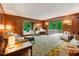 Relaxing living room offers a large window seat with natural light, wood paneling and cozy furniture at 4272 Boyd Wright Rd, Burlington, NC 27215