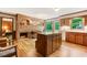 Inviting living room featuring wood cabinets, brick fireplace, and a beautiful view of nature at 4272 Boyd Wright Rd, Burlington, NC 27215