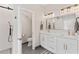 Modern bathroom featuring double vanity, sleek lighting, and a glass-enclosed shower at 4408 Queenstown Ct, Raleigh, NC 27612