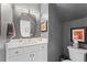 Stylish powder room with white vanity, gold fixtures, and modern mirror at 4408 Queenstown Ct, Raleigh, NC 27612