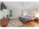 Inviting bedroom featuring hardwood floors, natural light, and neutral decor at 4408 Queenstown Ct, Raleigh, NC 27612