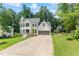 Gorgeous two-story home with a gray garage, well manicured yard and black trimmed windows at 4408 Queenstown Ct, Raleigh, NC 27612
