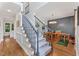 Beautiful foyer with a staircase and view into the dining room with gray accent wall at 4408 Queenstown Ct, Raleigh, NC 27612