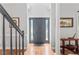 Beautiful foyer with hardwood floors and pillars, featuring a gray front door with sidelights at 4408 Queenstown Ct, Raleigh, NC 27612