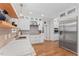 Modern kitchen featuring white cabinets, stainless steel appliances, and a stunning marble countertop at 4408 Queenstown Ct, Raleigh, NC 27612