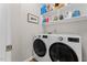 Efficient laundry room with front-load washer and dryer and ample storage shelves at 4408 Queenstown Ct, Raleigh, NC 27612